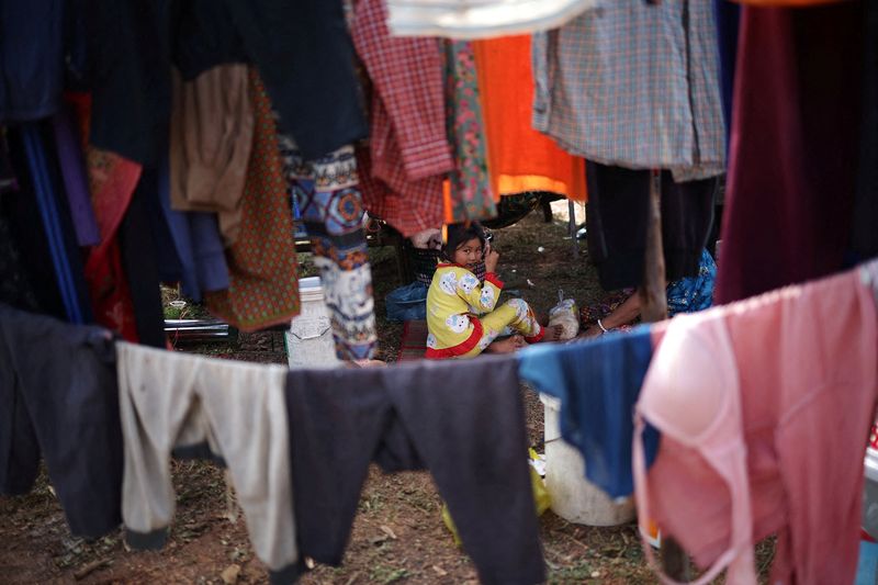 A girl eats a meal at Chong Kal refugee camp after evacuation amid deadly clashes between Thailand and Cambodia along a disputed border area, in Chong Kal, Oddar Meanchey Province, Cambodia, December 11, 2025.   REUTERS/Kim Hong-Ji