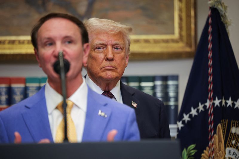 U.S. President Donald Trump listens as Governor of Louisiana Jeff Landry delivers remarks, in the Roosevelt Room at the White House, in Washington, D.C., U.S., March 24, 2025. REUTERS/Carlos Barria/File Photo