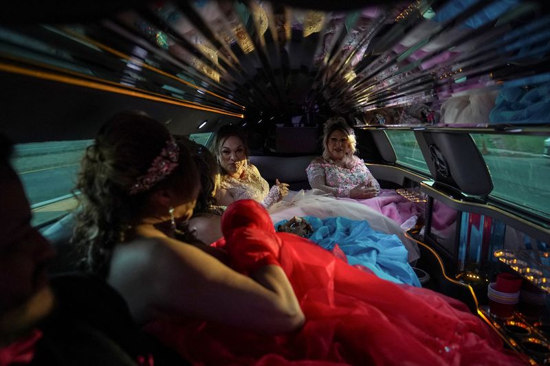 From left to right: Dilian Quijano, 58, Vickymar Castrellon, 54, Jessica Flores, 49, and Noemi Martinez, 54, ride in a limousine to the ballroom where they will celebrate their quinceanera in Houston, Texas, U.S., May 14, 2025. Castrellon and other transgender Latina immigrants were recently able to celebrate this year as quinceaneras - literally translated as 15-year-olds - thanks to the Organizacion Latina de Trans en Texas, a group promoting rights for LGBTQ+ people including transgender women from Latin America. "I never thought I'd get to my 50s," said Castrellon, who would sometimes as a teenager wear her friends' quinceanera gowns and pretend to be the girl of honor. "It's a dream I've always had, and I feel very happy because achieving it before I leave this world is something very beautiful for me." REUTERS/Gabriel V. Cardenas