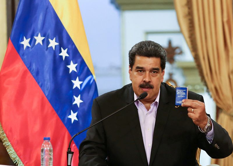 FILE PHOTO: Venezuela's President Nicolas Maduro holds a copy of the Venezuelan constitution while he speaks during a meeting with members of the Venezuelan diplomatic corp after their arrival from the United States, at the Miraflores Palace in Caracas, Venezuela January 28, 2019. Miraflores Palace/Handout via REUTERS/File Photo