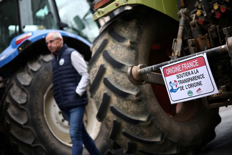 FILE PHOTO: French farmers gather with their tractors in front of the Vendee Prefecture during a day of actions called by French farm union FNSEA to protest against the planned EU-Mercosur free-trade deal with South American countries and U.S. tariffs, in La Roche-sur-Yon, France, September 26, 2025. The slogan reads "Origin France, support for transparency of origin".  REUTERS/Stephane Mahe/File Photo
