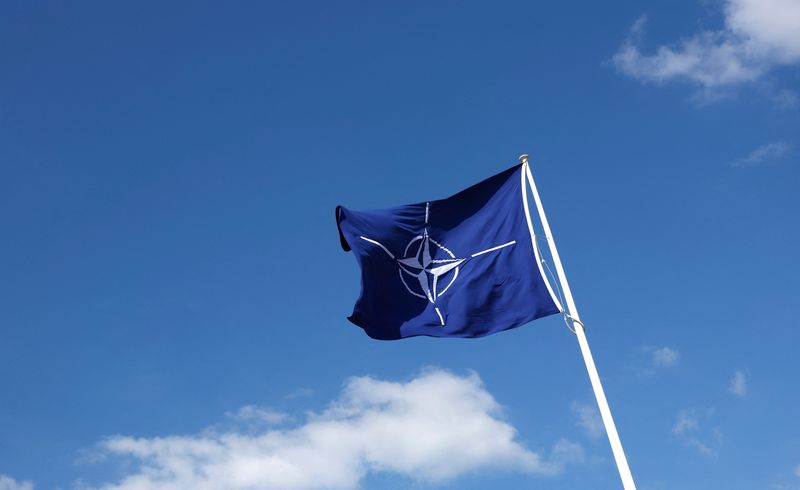 FILE PHOTO: A NATO flag flutters at NATO headquarters in Brussels, Belgium April 2, 2025. REUTERS/Yves Herman/File Photo