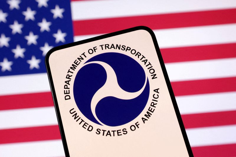 FILE PHOTO: United States Department of Transportation logo and U.S. flag are seen in this illustration taken April 23, 2025. REUTERS/Dado Ruvic/Illustration/File Photo