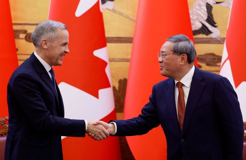 Canada's Prime Minister Mark Carney shakes hands with China's Premier Li Qiang at the end of the signing ceremony during the first visit by a Canadian prime minister to China since 2017, at the Great Hall of the People in Beijing, China January 15, 2026. REUTERS/Carlos Osorio