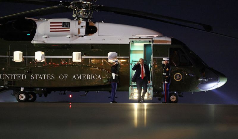 U.S. President Donald Trump walks from Marine One to board Air Force One as he departs West Palm Beach, Florida, U.S., January 19, 2026. REUTERS/Kevin Lamarque