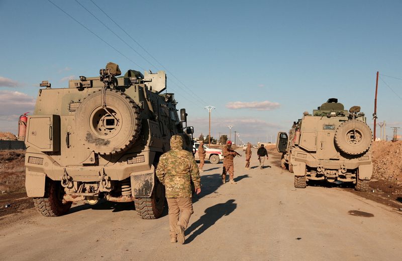 FILE PHOTO: Military members gather near Raqqa prison, where the Syrian army is besieging SDF members after the army took control of the city of Raqqa, Syria January 19, 2026. REUTERS/Mahmoud Hassano/File Photo
