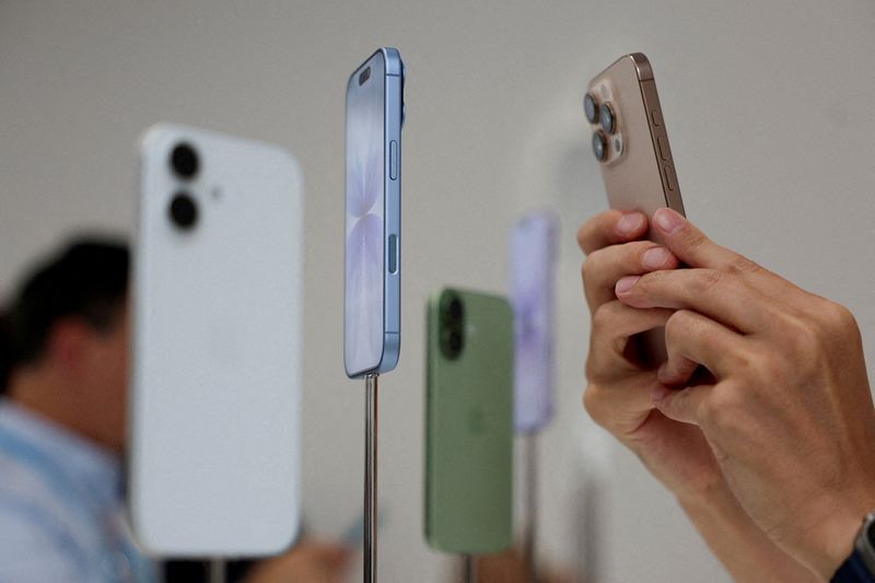 FILE PHOTO: FILE PHOTO: A person uses a phone to capture iPhones on display during Apple's event at the Steve Jobs Theater in Cupertino, California, U.S. September 9, 2025. REUTERS/Manuel Orbegozo/File Photo