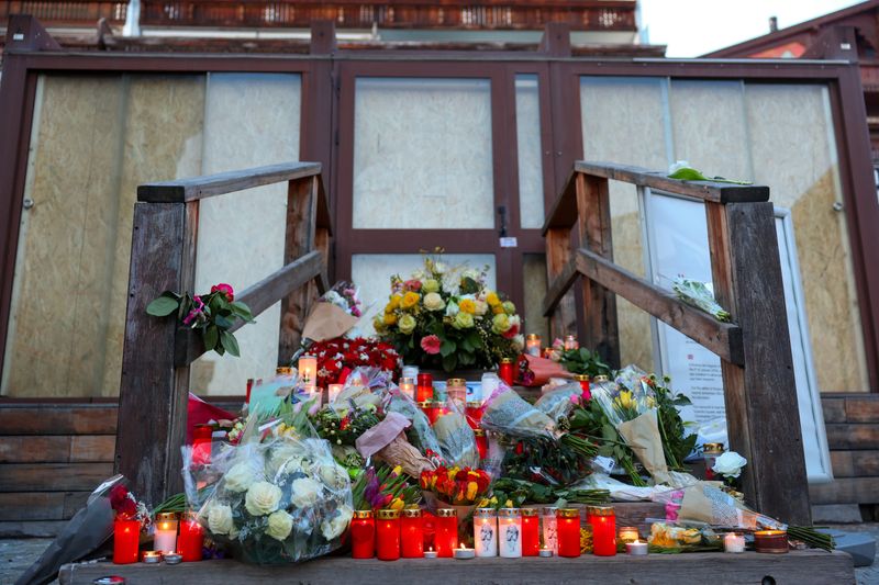 Flowers and candles at a makeshift memorial outside the "Le Constellation bar" almost a month after a deadly fire during a New Year's Eve party, in the upscale ski resort of Crans-Montana, Switzerland, January 31, 2026. REUTERS/Denis Balibouse