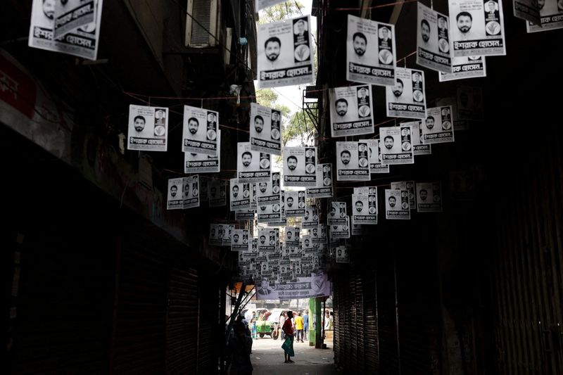 Election campaign posters hang over a street a day ahead of the national election in Dhaka, Bangladesh, February 11, 2026. REUTERS/Mohammad Ponir Hossain