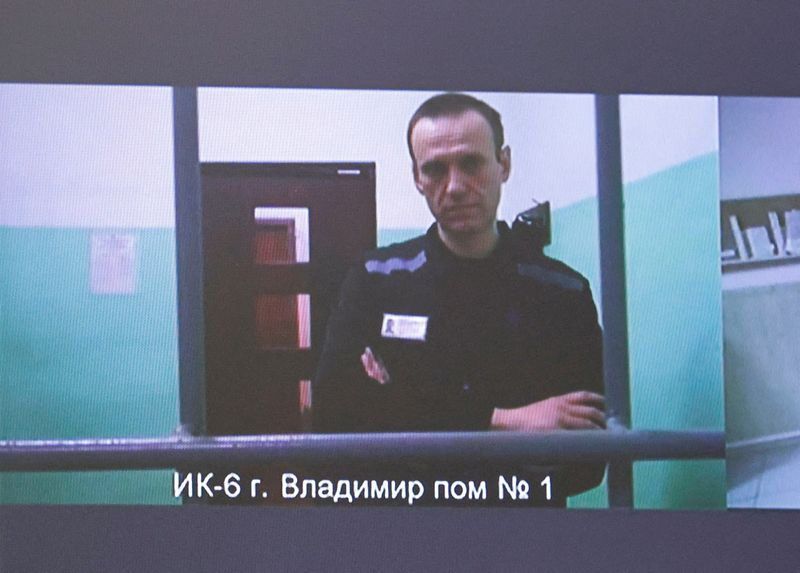 FILE PHOTO: Russian opposition politician Alexei Navalny appears on a screen via video link from the IK-6 penal colony in the Vladimir region, during a court hearing to consider an appeal against his sentence in the criminal case on numerous charges, including the creation of an extremist organization, in Moscow, Russia September 26, 2023. REUTERS/Yulia Morozova/File Photo