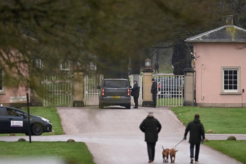 A police officer stands next to a vehicle outside Royal Lodge, a property on the estate surrounding Windsor Castle and a former residence of Andrew Mountbatten Windsor, younger brother of Britain’s King Charles, formerly known as Prince Andrew, who was arrested this morning on suspicion of misconduct in public office, BBC reports, after the U.S. Justice Department released more records tied to the late financier and convicted sex offender Jeffrey Epstein, in Windsor, Britain, February 19, 2026. REUTERS/Jaimi Joy