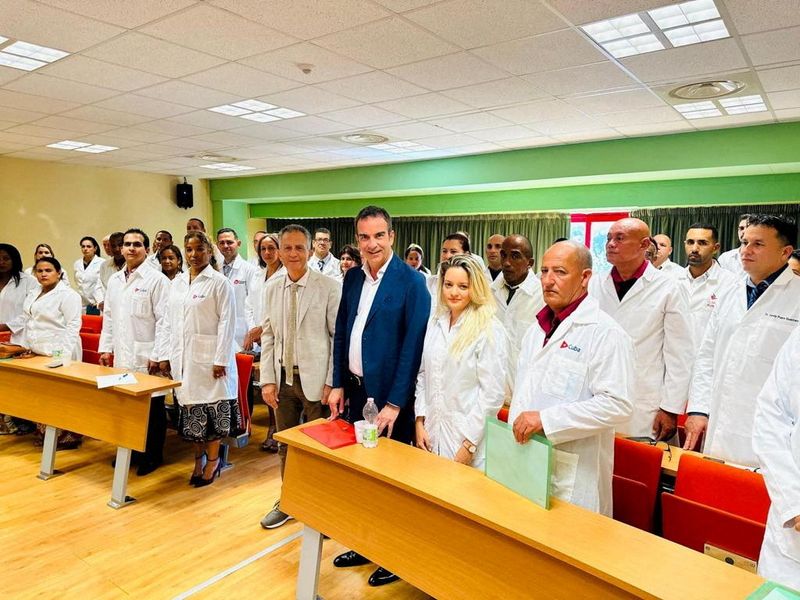 FILE PHOTO: Governor of Italy's Calabria region Roberto Occhiuto poses with Cuban medics whom he has hired to help deal with a shortage of staff in local hospitals, at the University of Calabria in Cosenza, Italy, in this undated picture obtained by Reuters on October 3, 2023. Calabria Region Press Office/Handout via REUTERS/File Photo