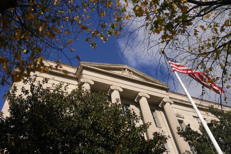 The U.S. flag flutters outside of the Department of Justice (DOJ) building in Washington, D.C., U.S., November 28, 2025. REUTERS/Nathan Howard