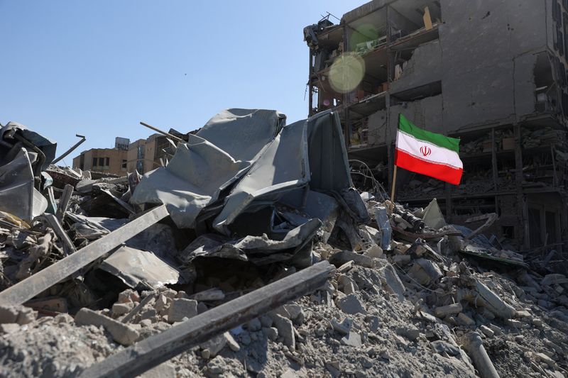 The national flag of Iran flies in the wind as debris lies scattered in the aftermath of an Israeli and U.S. strike on a police station, amid the U.S.-Israeli conflict with Iran, in Tehran, Iran, March 3, 2026. Majid Asgaripour/WANA (West Asia News Agency) via REUTERS