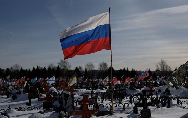 Flags fly over graves, including those of Russian soldiers killed during the conflict against Ukraine, on the eve of the fourth anniversary of the start of Russia’s military campaign, at Lemeshovo cemetery in the Moscow region, Russia, February 23, 2026. REUTERS/Ramil Sitdikov/File Photo