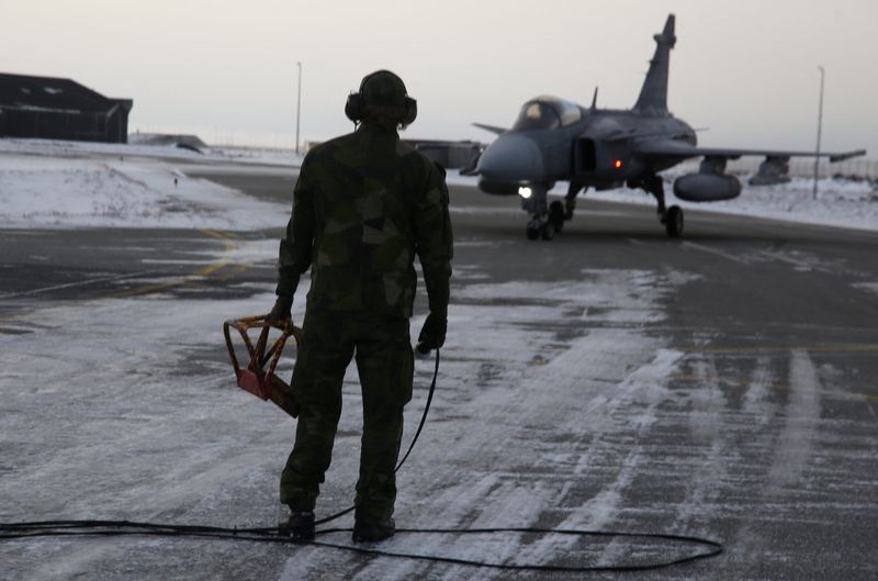 A Swedish ground crew member watches as a JAS 39 Gripen approaches on the tarmac at the air base in Keflavik, Iceland, March 3, 2026. REUTERS/Tom Little