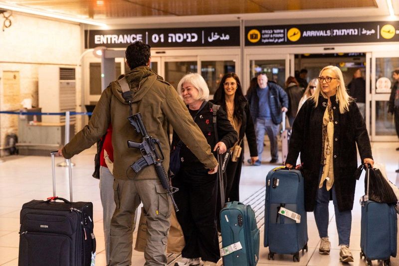 An Israeli soldier greets loved ones who returned to Israel from Italy on one of the first flights since Israel's airspace reopened, amid the U.S.-Israel conflict with Iran, at Ben Gurion International airport in Lod, Israel, March 5, 2026. Government Press Office/Handout via REUTERS