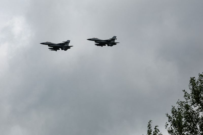 Ukrainian F-16 fighting aircrafts are seen in the air during marking the Day of the Ukrainian Air Forces, amid Russia's attack on Ukraine, in an undisclosed location, Ukraine August 4, 2024. REUTERS/Valentyn Ogirenko