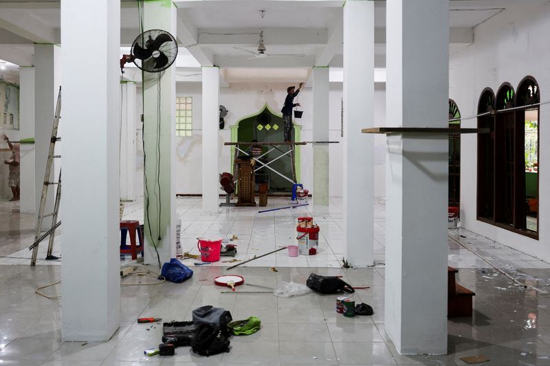 FILE PHOTO: Workers work inside a mosque where explosions occurred the previous day, at a school complex in Jakarta, Indonesia, November 8, 2025. REUTERS/Willy Kurniawan/File Photo