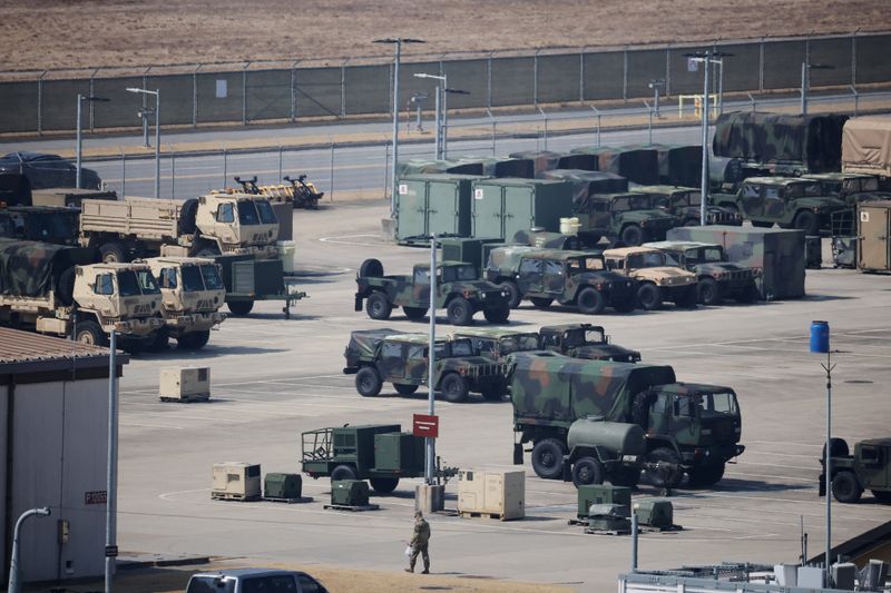 A U.S. army soldier walks past military vehicles at a U.S army base in Pyeongtaek, South Korea, March 10, 2026.   REUTERS/Kim Hong-Ji