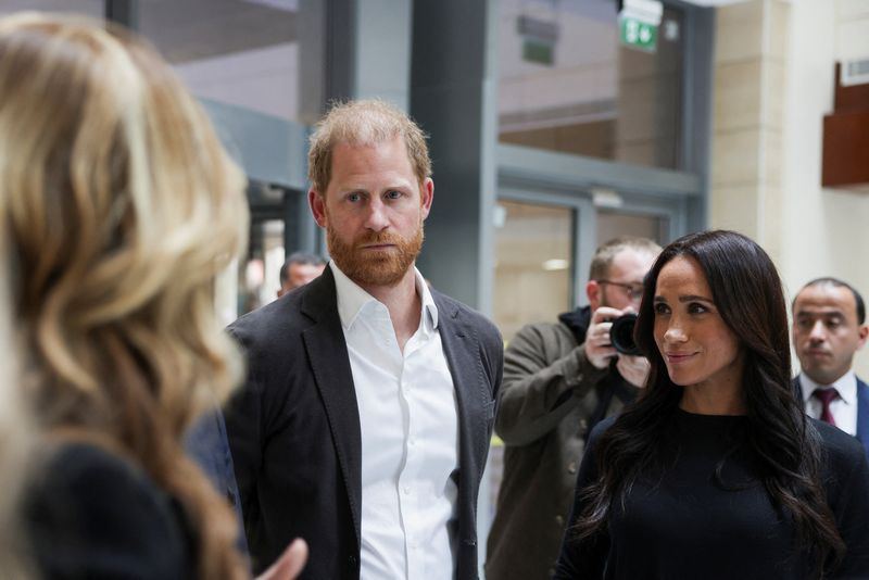Britain's Prince Harry and Meghan, the Duchess of Sussex, listen as they visit the King Hussein Cancer Center accompanied by a delegation from the World Health Organization in Amman, Jordan, February 26, 2026. REUTERS/Alaa Al Sukhni