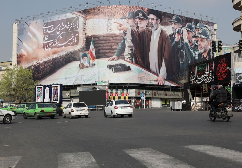 Cars pass a banner featuring Iran's new Supreme Leader Mojtaba Khamenei, amid the U.S.-Israeli conflict with Iran, in Tehran, Iran, March 14, 2026. Majid Asgaripour/WANA (West Asia News Agency) via REUTERS