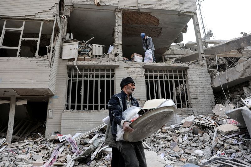 A man walks amid rubble in the aftermath of a strike, amid the U.S.-Israeli conflict with Iran, in Tehran, Iran, March 12, 2026. Majid Asgaripour/WANA (West Asia News Agency) via REUTERS