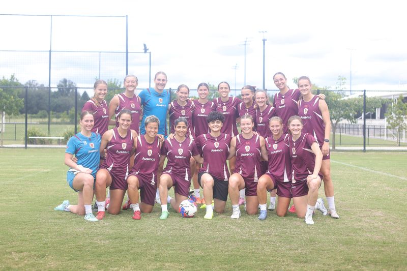Iranian soccer players Atefeh Ramezanizadeh and Fatemeh Pasandideh pose for a photo with members of Brisbane Roar women's football club, in Brisbane, Australia, March 16, 2026. Brisbane Roar/Handout via REUTERS