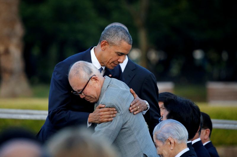 FILE PHOTO: U.S. President Barack Obama (L) hugs atomic bomb survivor Shigeaki Mori as he visits Hiroshima Peace Memorial Park in Hiroshima, Japan May 27, 2016. REUTERS/Carlos Barria/File Photo