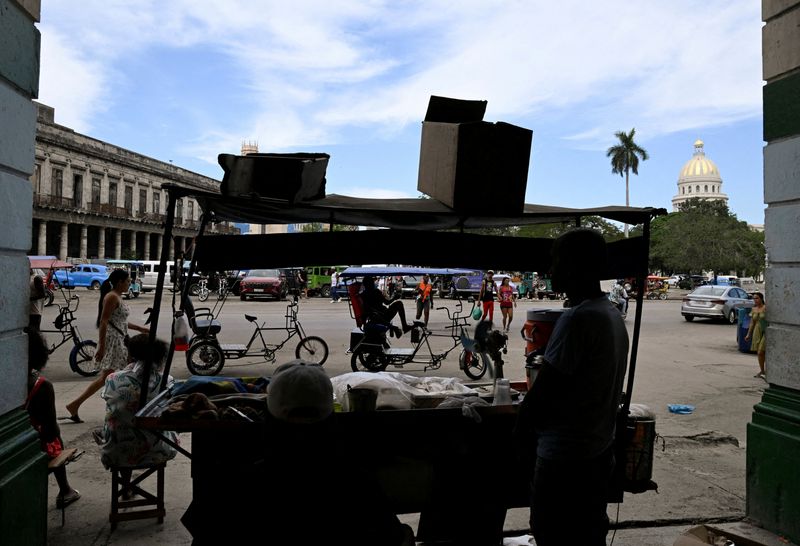FILE PHOTO: People spend time in a commercial area as U.S.-Cuba tensions rise after U.S. President Donald Trump vowed to stop Venezuelan oil and money from reaching Cuba and suggested the communist-run island to strike a deal with Washington, in Havana, Cuba, January 11, 2026. REUTERS/Norlys Perez/File Photo