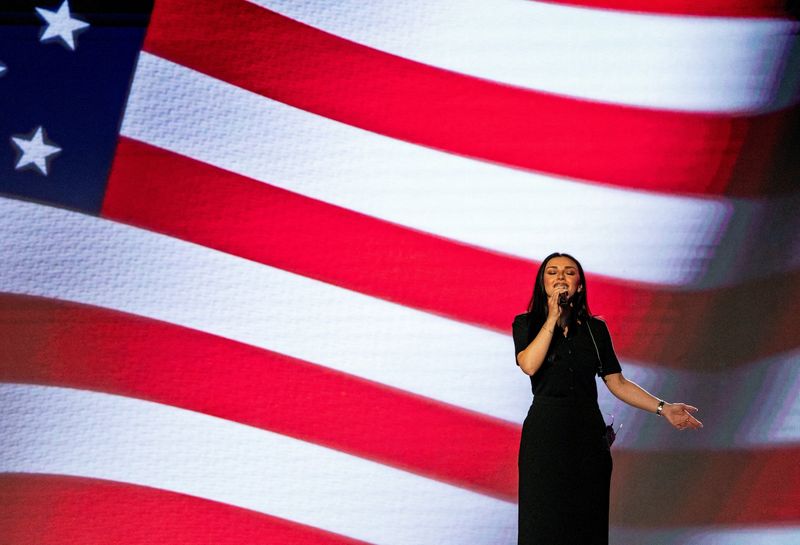 FILE PHOTO: Political Commentator and Country Music Artist Alexis Wilkins sings the National Anthem at the 2026 International Christian Media Convention held at the Gaylord Opryland Resort and Convention Center in Nashville, Tennessee, U.S., February 19, 2026.  REUTERS/Seth Herald/File Photo