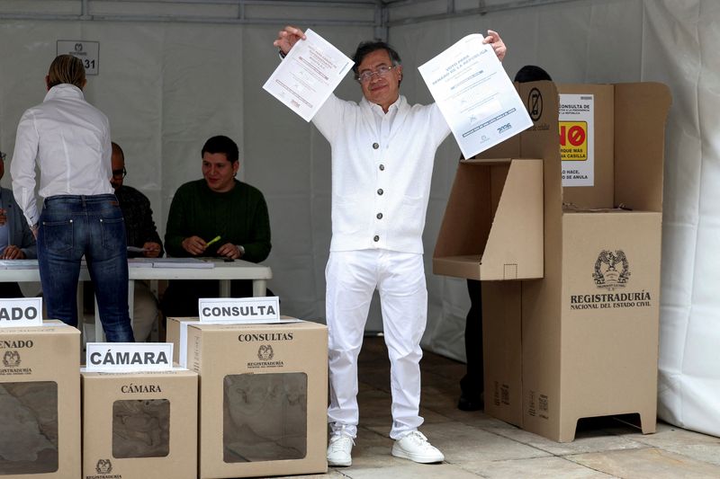 Colombian President Gustavo Petro shows the ballot papers before casting his vote in congressional elections and party primaries for presidential candidate, in Bogota, Colombia, March 8, 2026. REUTERS/Luisa Gonzalez