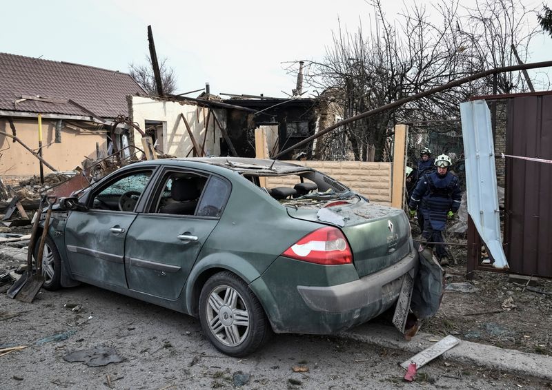 Rescuers work at the site of a building hit by a Russian drone strike, amid Russia's attack on Ukraine, in Zaporizhzhia, Ukraine March 21, 2026. REUTERS/Stringer
