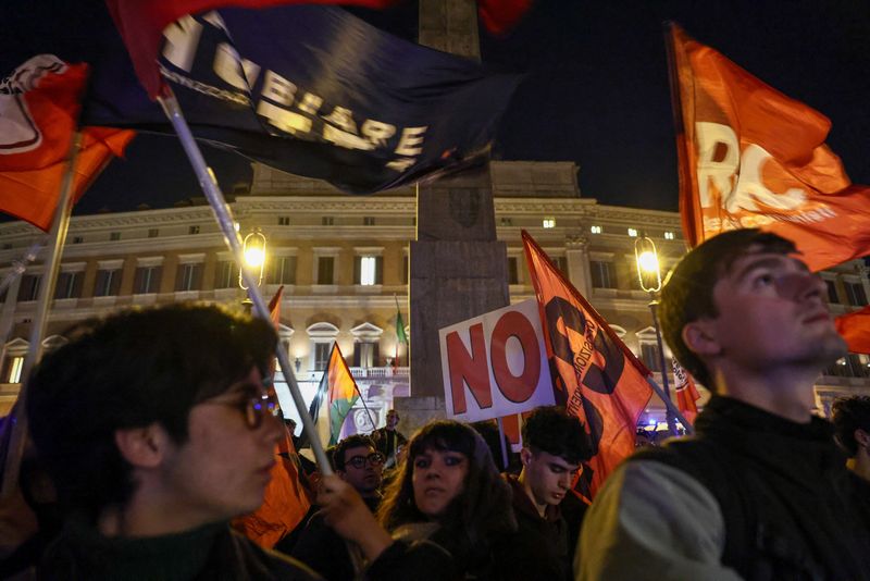 Supporters of the "No" to the constitutional referendum on justice reform wave flags and hold "No" signs as they celebrate their victory in Rome, Italy, March 23, 2026. REUTERS/Matteo Minnella