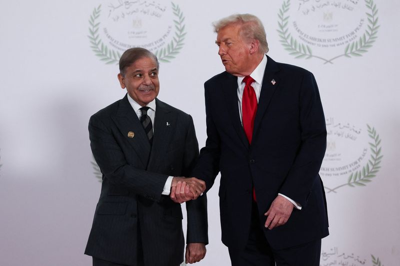 U.S. President Donald Trump and Pakistani Prime Minister Shehbaz Sharif shake hands as they pose for a photo, at a world leaders' summit on ending the Gaza war, amid a U.S.-brokered prisoner-hostage swap and ceasefire deal between Israel and Hamas, in Sharm el-Sheikh, Egypt, October 13, 2025. REUTERS/Suzanne Plunkett/Pool