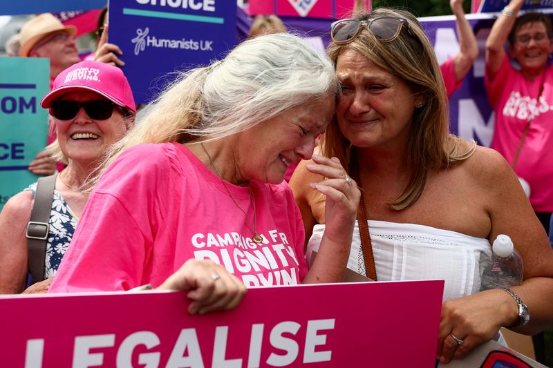 Elizabeth Alexander and Jane Edwards react after Britain's parliament voted in favour of a bill to legalise assisted dying, in Westminster, London, Britain, June 20, 2025. REUTERS/Isabel Infantes