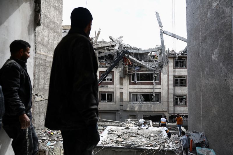 A man looks at a residential building damaged by a strike, amid the U.S.-Israeli conflict with Iran, in Tehran, Iran, March 27, 2026. Majid Asgaripour/WANA (West Asia News Agency) via REUTERS