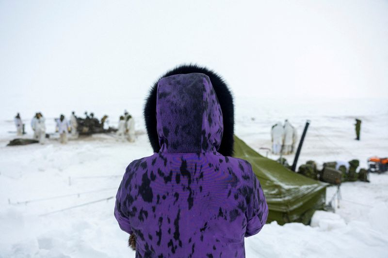 FILE PHOTO: A resident watches as the 1st Regiment, Royal Canadian Horse Artillery works with an M777 Howitzer as Canadian Armed Forces deploy to 'Operation Nanook-Nunalivut', a yearly series of drills designed to highlight the military’s ability to defend the Canadian Arctic, in Cambridge Bay, Nunavut, Canada February 19, 2026. REUTERS/Carlos Osorio/File Photo