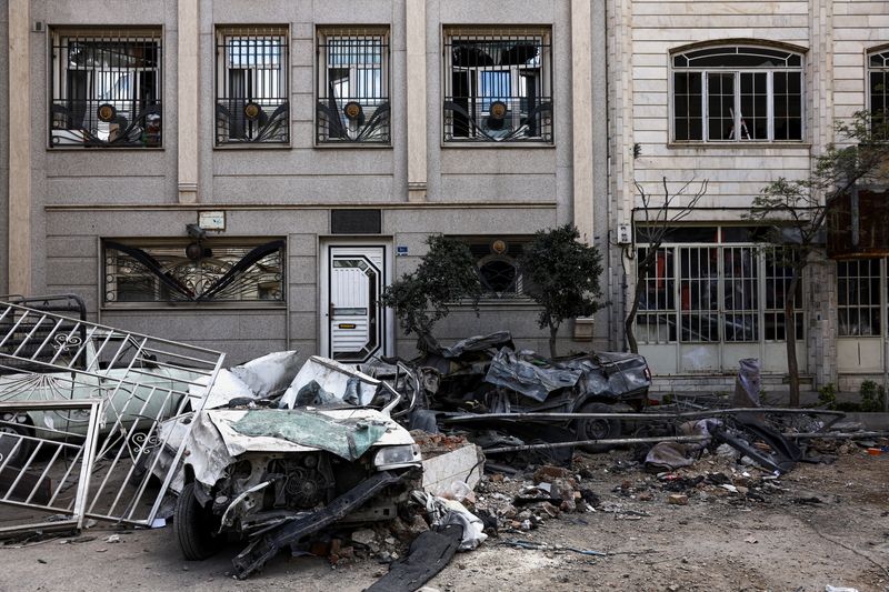 Car wrecks and a residential building damaged by a strike amid the U.S.-Israeli conflict with Iran, in Tehran, Iran, March 30, 2026. Majid Asgaripour/WANA (West Asia News Agency) via REUTERS