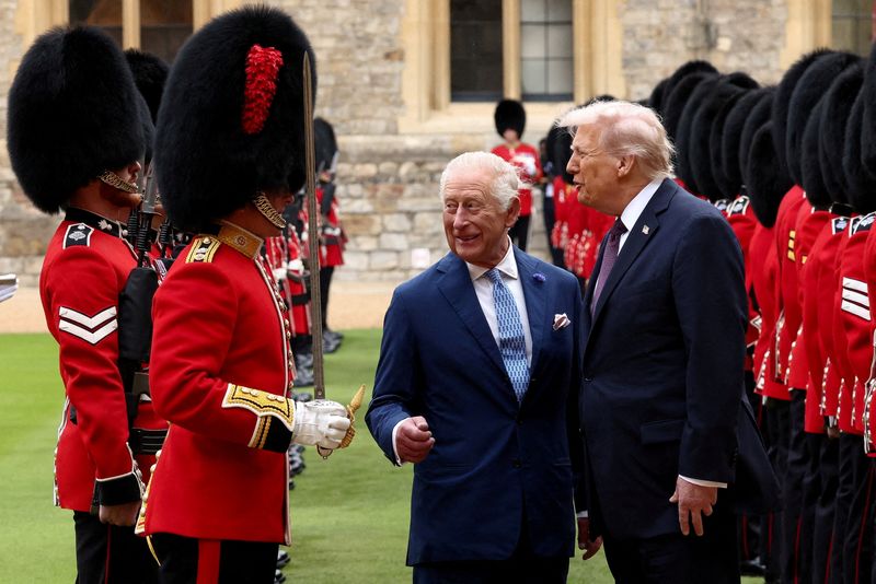 FILE PHOTO: U.S. President Donald Trump and Britain's King Charles inspect the Guard of Honour as they attend a welcome ceremony during Trump's state visit, at Windsor Castle, in Windsor, Britain, September 17, 2025. REUTERS/Kevin Lamarque/File Photo