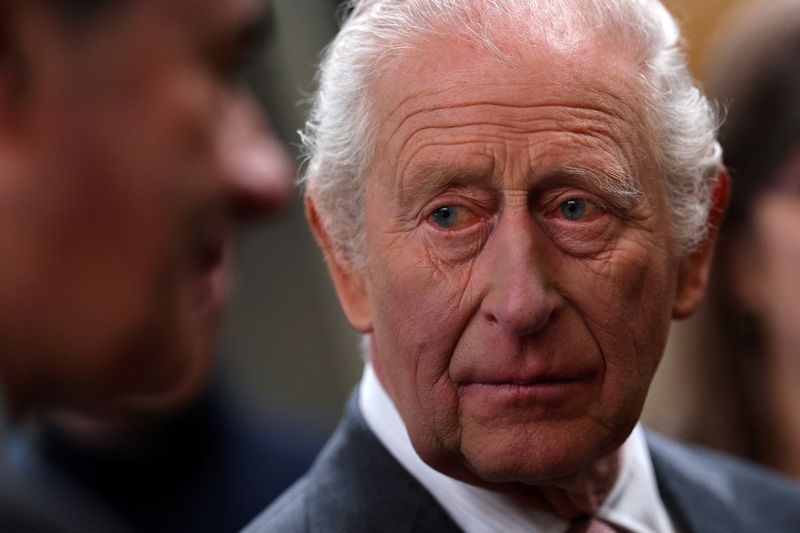 Britain's King Charles meets members of the local community with during a visit to The Market Hall in St Austell, Britain, March 24, 2026.  ADRIAN DENNIS/Pool via REUTERS