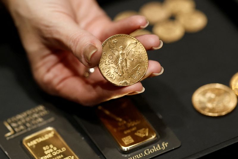 A Mexican 50 pesos gold coin is displayed at a Comptoir national de l'Or store in Paris, France, February 3, 2026. REUTERS/Benoit Tessier