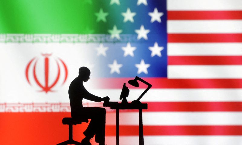 FILE PHOTO: Figurines with computers are seen in front of USA and Iran flags in this illustration created on September 10, 2022. REUTERS/Dado Ruvic/Illustration/File Photo
