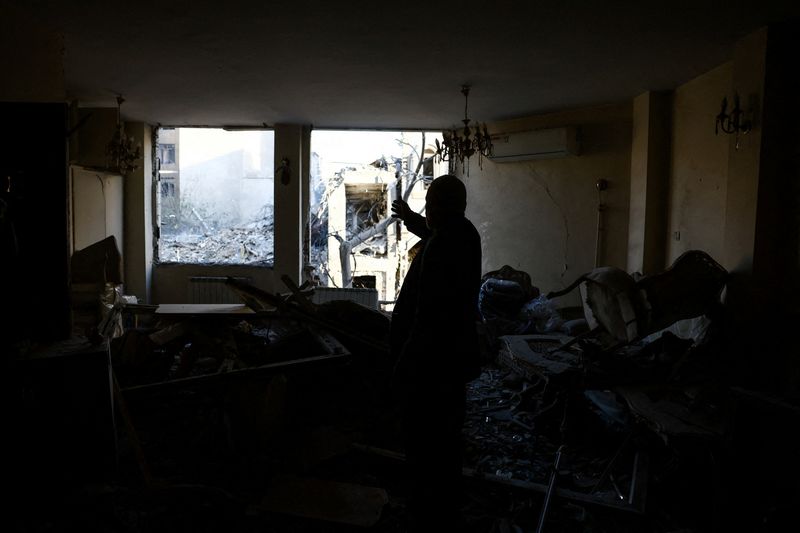 A man stands at his home near a Synagogue, which was damaged in a strike, amid the U.S.-Israeli conflict with Iran, in Tehran, Iran, April 7, 2026. Majid Asgaripour/WANA (West Asia News Agency) via REUTERS