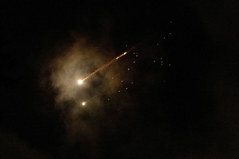 Streaks of light illuminate the sky during an interception attempt, amid the U.S.-Israeli conflict with Iran, as seen from Jerusalem, April 8, 2026. REUTERS/Itay Cohen