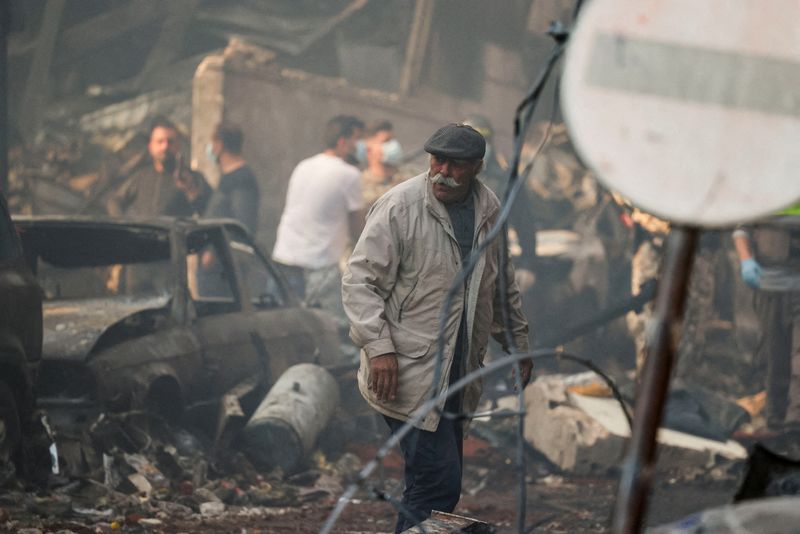 A man walks at the site of an Israeli strike, in Al-Mazraa in Beirut, Lebanon. REUTERS/Yara Nardi