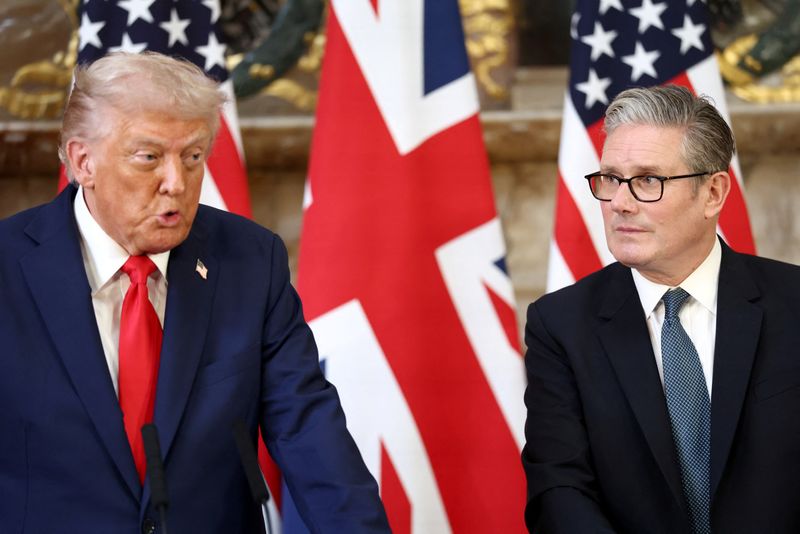 British Prime Minister Keir Starmer listens as U.S. President Donald Trump speaks during a press conference following their meeting at Chequers, near Aylesbury, Britain, September 18, 2025. REUTERS/Kevin Lamarque