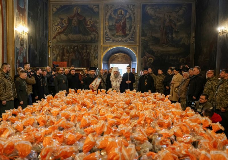 FILE PHOTO: Metropolitan Epiphanius I, head of the Orthodox Church of Ukraine, prepares to sprinkle holy water to bless Easter cakes which are to be transferred to Ukrainian servicemen fighting on the frontline amid Russia's attack on Ukraine, during a ceremony at St Michael's Cathedral before Orthodox Easter, in Kyiv, Ukraine April 9, 2026. REUTERS/Stringer/File Photo
