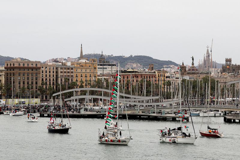 The Sagrada Familia basilica appears in the distance as boats taking part in a humanitarian flotilla depart for Gaza from Barcelona, Spain, April 12, 2026. REUTERS/Nacho Doce