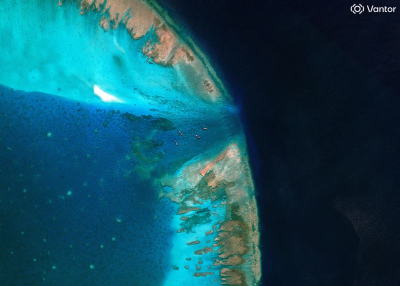 A satellite image of fishing vessels at the entrance, which is blocked by a floating barrier, to the disputed Scarborough Shoal, in the South China Sea, April 11, 2026. Vantor/Handout via REUTERS